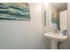 Small bathroom with pedestal sink, and beach-themed decor at 3339 E Tonopah Dr, Phoenix, AZ 85050