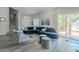 Bright living room featuring a large sectional sofa and sliding glass doors at 3339 E Tonopah Dr, Phoenix, AZ 85050