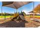 Modern playground equipment under shaded areas at 384 W Chuckwagon Ln, San Tan Valley, AZ 85143