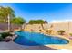 Relaxing backyard oasis featuring a kidney-shaped pool and lush landscaping at 384 W Chuckwagon Ln, San Tan Valley, AZ 85143