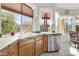 Kitchen with granite countertops, wooden cabinets, and a stainless steel dishwasher at 4735 E Azalea Dr, Gilbert, AZ 85298