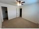 Bright bedroom with ceiling fan and access to hallway at 5520 N Granite Reef Rd, Scottsdale, AZ 85250