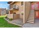 Exterior view of condo building showing stairs, landscaping, and a private patio at 5525 E Thomas Rd # N1, Phoenix, AZ 85018