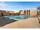 Inviting community pool with surrounding lounge chairs and building in background at 5525 E Thomas Rd # N1, Phoenix, AZ 85018