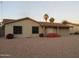 Tan one-story house with a two-car garage and pink flowers at 814 W Hononegh Dr, Phoenix, AZ 85027