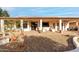 Relaxing backyard with covered patio, gravel landscaping, and potted plants at 9501 E Cherrywood Dr, Sun Lakes, AZ 85248