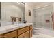 Clean bathroom with tiled floors, bathtub, and wood vanity at 9501 E Cherrywood Dr, Sun Lakes, AZ 85248