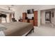 Primary bedroom with built-ins, TV, and access to bathroom and hallway at 9501 E Cherrywood Dr, Sun Lakes, AZ 85248