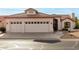 Single-story home with three-car garage and desert landscaping at 9501 E Cherrywood Dr, Sun Lakes, AZ 85248