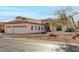 Single-story home with three-car garage and desert landscaping at 9501 E Cherrywood Dr, Sun Lakes, AZ 85248