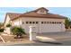 Single-story home with three-car garage and desert landscaping at 9501 E Cherrywood Dr, Sun Lakes, AZ 85248