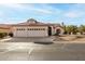 Single-story home with three-car garage and desert landscaping at 9501 E Cherrywood Dr, Sun Lakes, AZ 85248