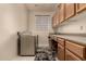 Laundry room with washer, dryer, and built-in cabinets at 9501 E Cherrywood Dr, Sun Lakes, AZ 85248