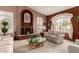 Living room with fireplace, large windows, and neutral decor at 9501 E Cherrywood Dr, Sun Lakes, AZ 85248