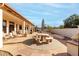 Spacious flagstone patio with seating area, umbrella, and built-in grill at 9501 E Cherrywood Dr, Sun Lakes, AZ 85248