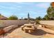 Outdoor patio features a round table, built-in grill and umbrella at 9501 E Cherrywood Dr, Sun Lakes, AZ 85248