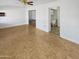 Living room with wood-look flooring and adjacent laundry area at 10238 W Cumberland Dr, Sun City, AZ 85351