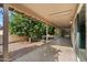 Covered patio in the backyard with citrus trees and a gravel area at 1462 Leisure World --, Mesa, AZ 85206