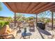 Outdoor entertaining space with barbecue grill and covered patio at 17539 W Silver Fox Way, Goodyear, AZ 85338