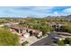 Aerial view of a community with tile-roofed homes, desert landscaping, and mountain views at 19550 N Grayhawk Dr # 1144, Scottsdale, AZ 85255