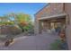 Exterior view of covered patio, landscaping, and stone exterior at 19550 N Grayhawk Dr # 1144, Scottsdale, AZ 85255