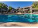 Community pool with shaded seating area, hot tub, and lush landscaping at 255 S Kyrene Rd # 133, Chandler, AZ 85226