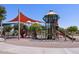 A playground with slides and climbing features under a large shade structure at 2629 E Santa Ynez Dr, Casa Grande, AZ 85194