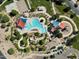 Aerial view of the community pool, waterslide, playground, and shaded seating areas at 2635 E Santa Ynez Dr, Casa Grande, AZ 85194