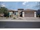 Single-story home with stone accents and a two-car garage at 26392 W Abraham Ln, Buckeye, AZ 85396