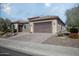 Single-story home with paver driveway and desert landscaping at 26392 W Abraham Ln, Buckeye, AZ 85396