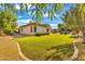 Lush green backyard with a paved patio and mature trees at 2879 E Portola Valley Ct, Gilbert, AZ 85297