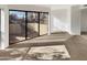 Large bedroom with sliding glass doors and carpeted flooring at 3228 W Glendale Ave # 118, Phoenix, AZ 85051