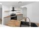 Modern kitchen with gray cabinets, wood countertops, and stainless steel appliances at 3228 W Glendale Ave # 118, Phoenix, AZ 85051