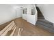 Open living room area with wood flooring and a staircase at 3228 W Glendale Ave # 118, Phoenix, AZ 85051