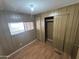 Bedroom with wood-look flooring, closet, and built-in drawers at 4065 E University Dr # 334, Mesa, AZ 85205