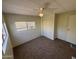 Carpeted bedroom with ceiling fan, closet, and windows at 4065 E University Dr # 334, Mesa, AZ 85205