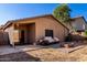 Spacious backyard with covered patio, fire pit, and desert landscaping at 41752 W Sunland Dr, Maricopa, AZ 85138