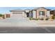 Inviting single-story home with a stone and stucco facade, and a two-car garage at 4222 W Carmen St, Laveen, AZ 85339