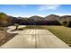 Fenced backyard with patio, grass, and desert landscaping at 4481 E Sundance Ct, Gilbert, AZ 85297