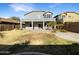 Two-story home with covered patio, grassy backyard, and desert landscaping at 4481 E Sundance Ct, Gilbert, AZ 85297