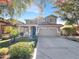 Charming two-story home with a gray exterior, landscaped front yard, and attached two-car garage at 4481 E Sundance Ct, Gilbert, AZ 85297