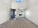 Bright living room with high ceilings, large windows, and carpeted floors at 4481 E Sundance Ct, Gilbert, AZ 85297