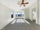 Spacious main bedroom with carpeted floors, large windows, and a ceiling fan at 4481 E Sundance Ct, Gilbert, AZ 85297