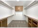 Spacious walk-in closet with built-in wooden shelving and ample storage space at 4481 E Sundance Ct, Gilbert, AZ 85297