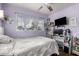 A purple bedroom featuring a bed, ceiling fan, a TV, and storage drawers at 453 S Miller St, Mesa, AZ 85204