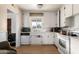 Bright kitchen featuring white appliances and wood-look flooring at 453 S Miller St, Mesa, AZ 85204