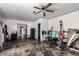 Living area with exercise equipment, a ceiling fan, and a view into another room at 453 S Miller St, Mesa, AZ 85204