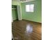 Light green bedroom with wood-look floors and closet at 4921 W Glenrosa Ave, Phoenix, AZ 85031