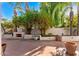 Spacious backyard patio with a fireplace and lush landscaping at 7385 E Pleasant Run, Scottsdale, AZ 85258