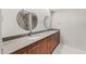 Modern bathroom featuring dual sinks, circular mirrors, and updated fixtures at 7385 E Pleasant Run, Scottsdale, AZ 85258